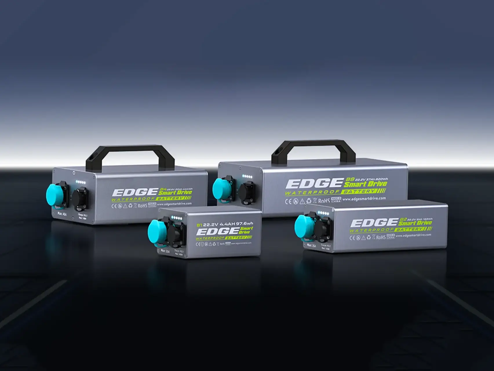 The Edge K4 modular lithium battery family for kayaks, displayed in a studio setting showing various sizes and the sleek silver waterproof housing.