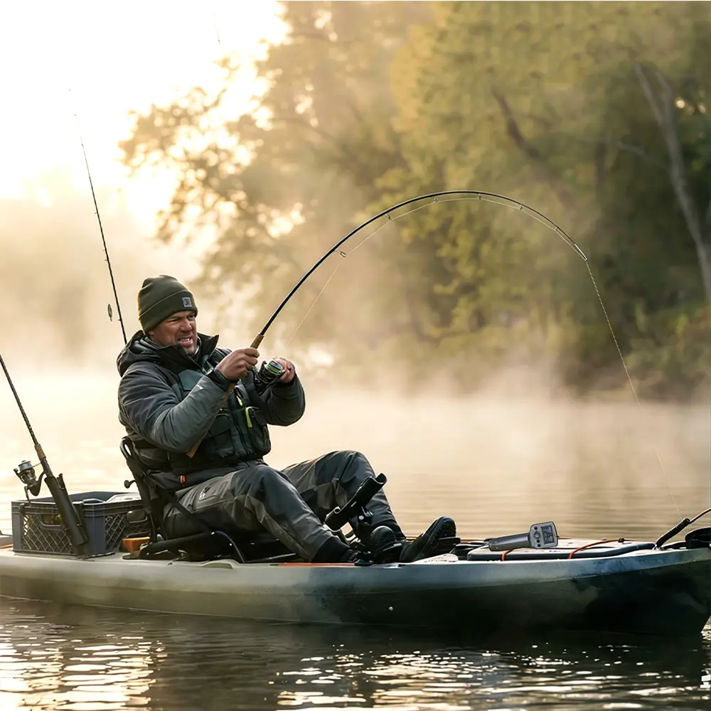 Angler fly fishing from a small skiff in a marshy area. The quiet EDGE K4 electric motor allows for hands-free maneuvering to approach fish stealthily.