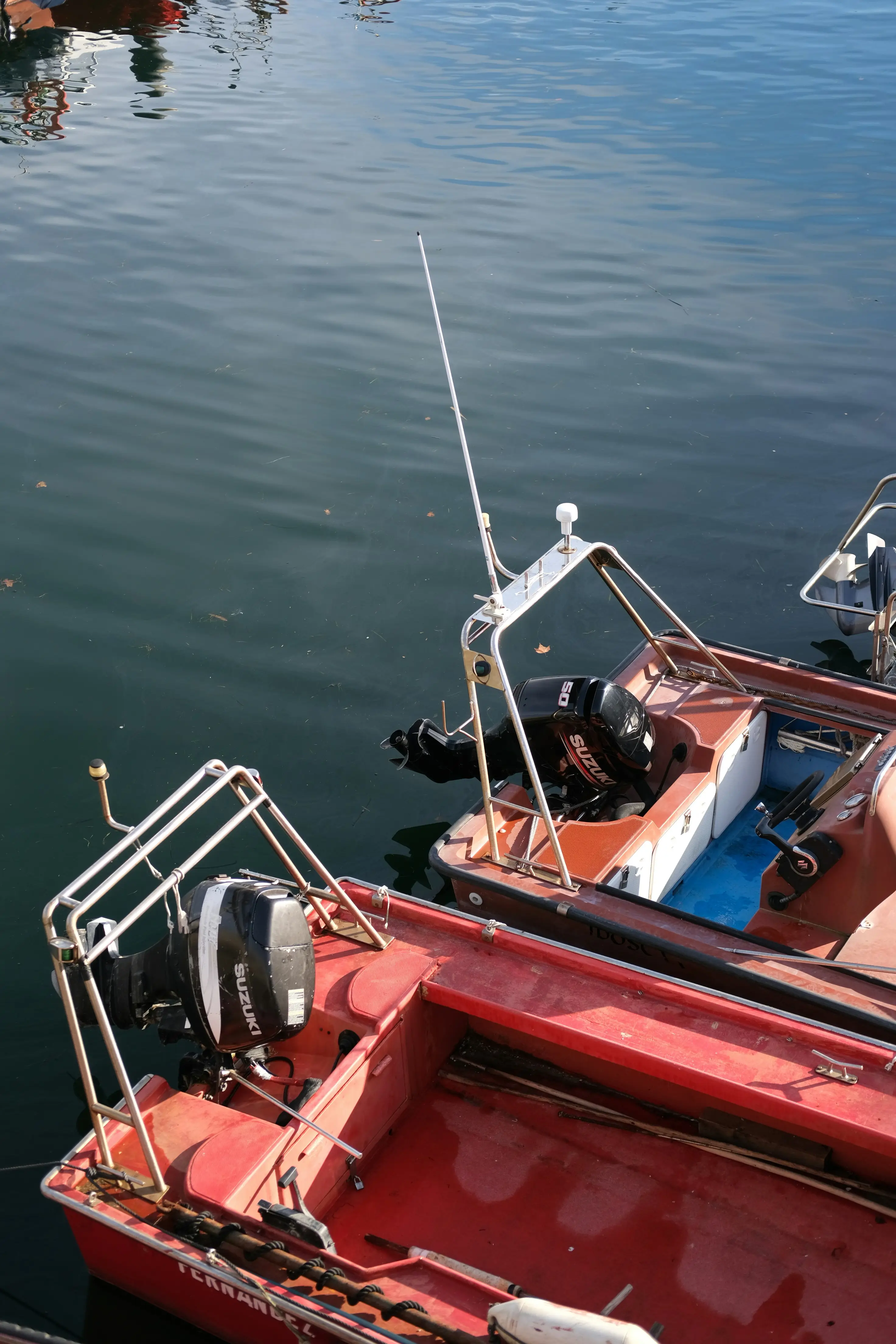 Small boat with gas outboard motor stored at dock during off-season