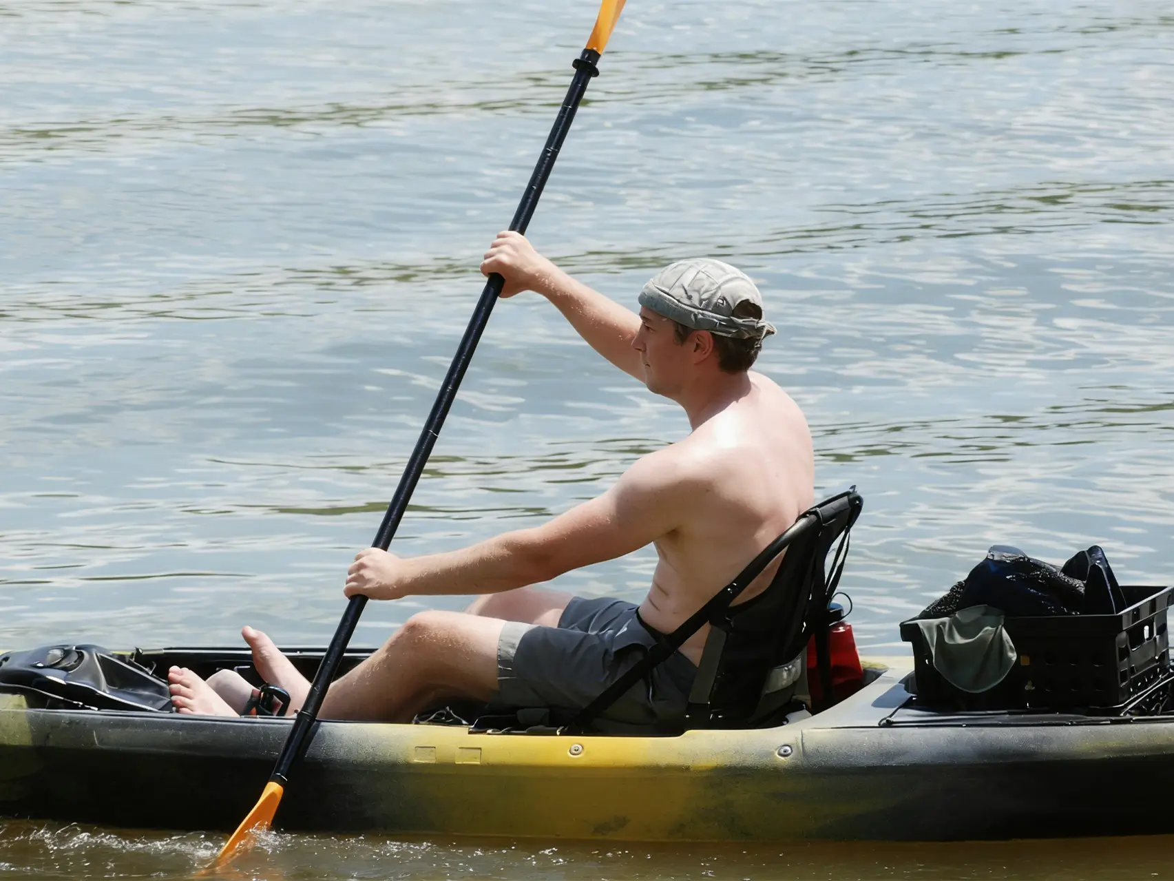 kayak fishing setup on calm water, paddling to reach offshore structure”